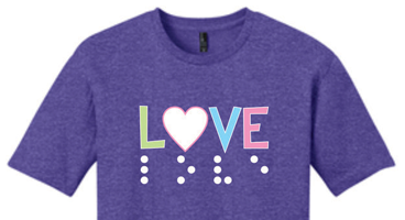 A t-shirt that says LOVE in print and tactile Braille. 