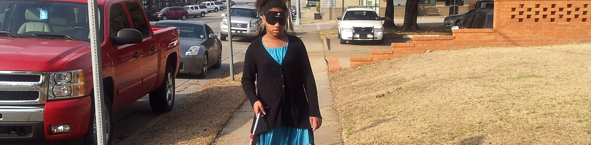 Malayja traveling confidently with her cane in downtown Ruston.