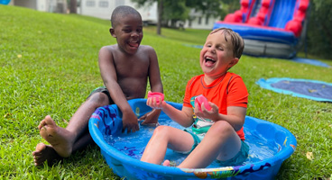 Heniston and Emerson play with water balloons at the BELL Cele-A-Bration.